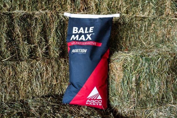 Image of hay bales with a bag of the BaleMax granular hay preservative.